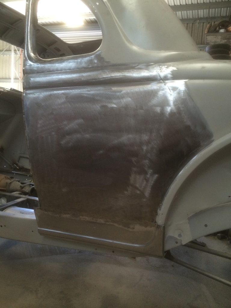 Here the door skin is fitted to the quarter panel and lower rust repair panel fitted.